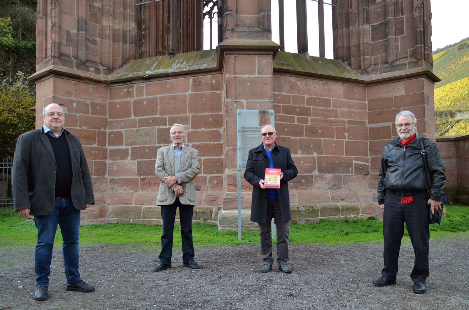 Buchvorstellung an der Wernerkapelle. V.l.n.r.: Bacharachs katholischer Pfarrer Michael Knipp, Peter Keber, VG-Bürgermeister Karl Thorn, Walter Karbach. Foto: Jochen Schlosser.
